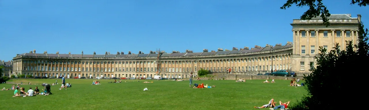 The curved Georgian terrace of the Royal Crescent in Bath, seen across the lawn